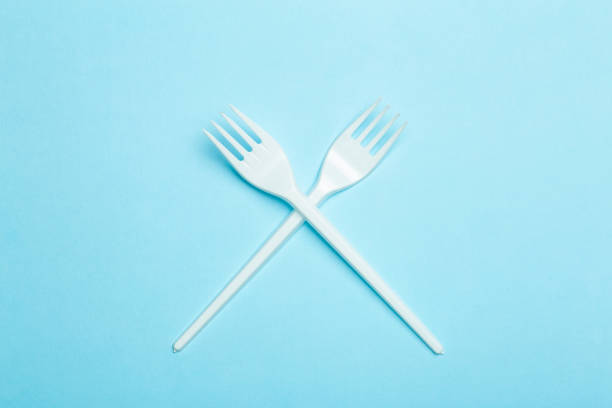istock Plastic forks on a blue background. Plastic waste and pollution concept 1309129417