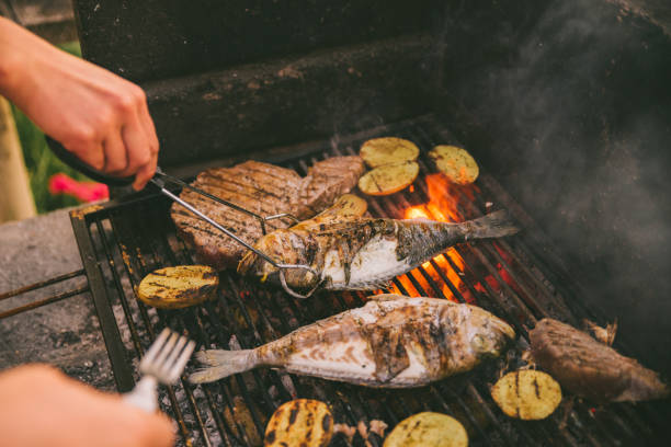 istock cooking fish and potatoes on grill 1309129832