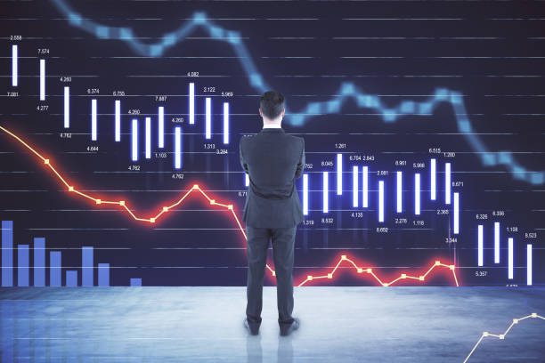 istock Crisis concept with businessman looking at big digital screen with falling financial chart graphs and quotes 1309130361