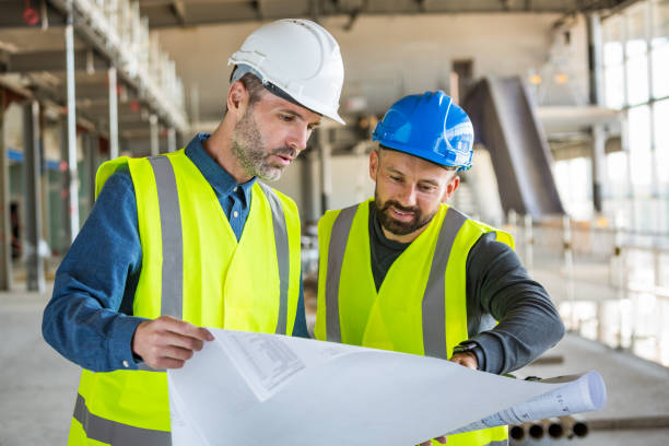 istock Architect and electrician at an indoor construction site 1309130468