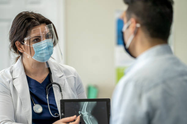 istock Masked Medical Appointment 1309130674