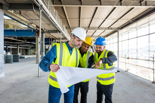 istock Architect, electrician and builder at an indoor construction site 1309130895