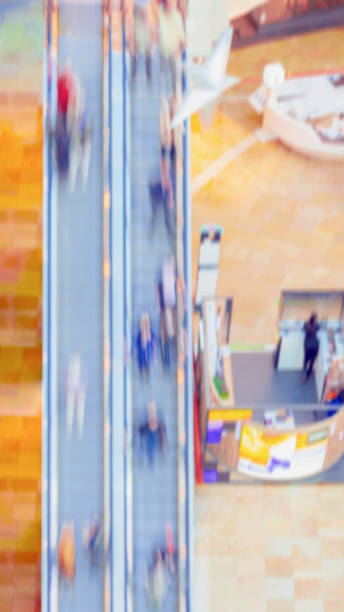 istock Abstract blurred People in shopping mall, unrecognizable people on escalator, top view. Motion effect 1309133652