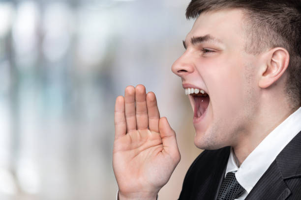 istock Closeup businessman shouting on blurred background. 1309134027