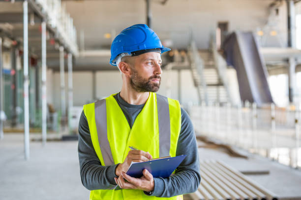 istock Electrician at an indoor construction site 1309134184