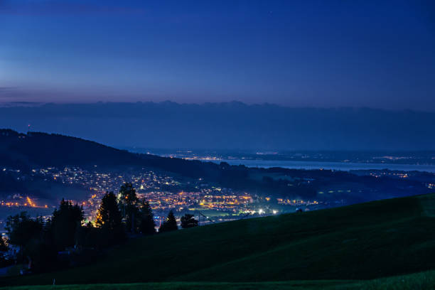 Herisau at night with lGermany and lake Constance in the background, Switzerland Herisau is the capital city of the Canton Appenzell Ausserrhoden in Switzerland. Photo was taken at dusk from Lutzenland. appenzell ausserrhoden stock pictures, royalty-free photos & images