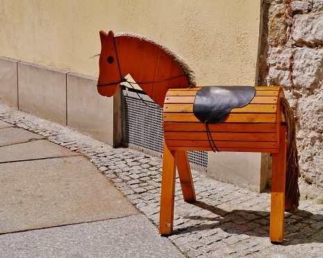 Toy horse in front of the wall