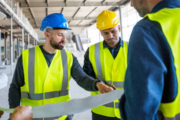 istock Electrician talking with team at construcion site 1309135206