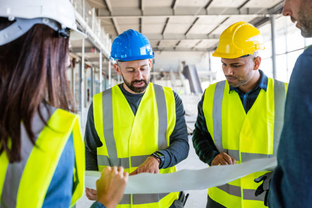 istock Electrician talking with team at construcion site 1309135379