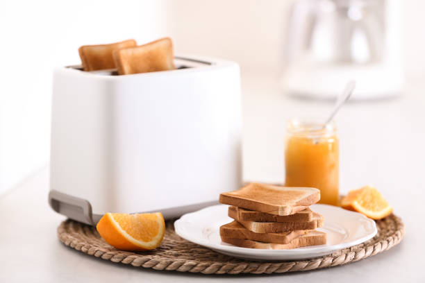 istock Modern toaster and delicious breakfast on table in kitchen 1309135849