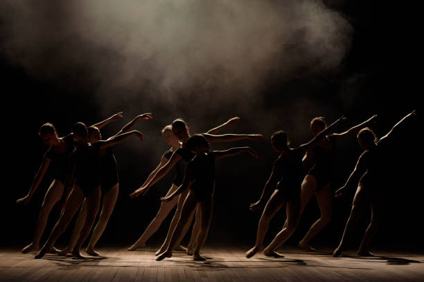 istock Young ballerinas rehearsing in the ballet class. They perform different choreographic exercises and stand in different positions 1309135898