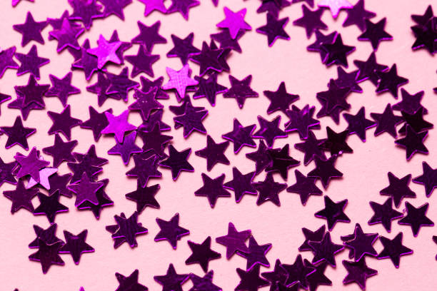 istock Closeup asterisks sprinkled on a pink isolated background. View from above 1309138300