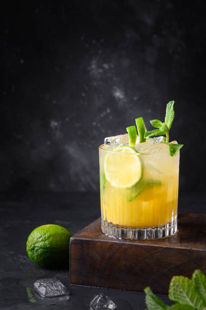 Mai Tai Classic rum cocktail. Tropical lemonade with lime on black. Mai Tai Classic rum cocktail. Tropical lemonade with lime on black. Vertical format. lemon soda photos stock pictures, royalty-free photos & images