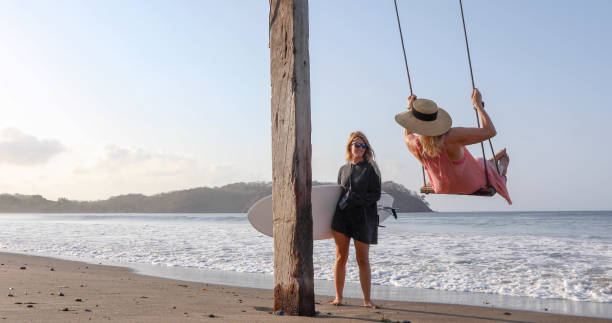 istock Women exchange greetings on sandy beach 1309139611