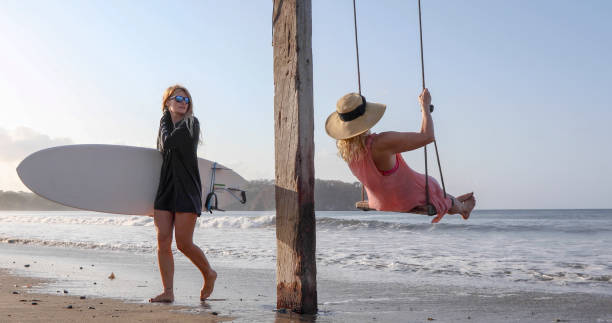 Women exchange greetings on sandy beach