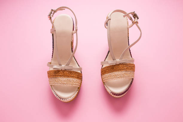 istock Female summer sandals on a pink background close-up 1309139679
