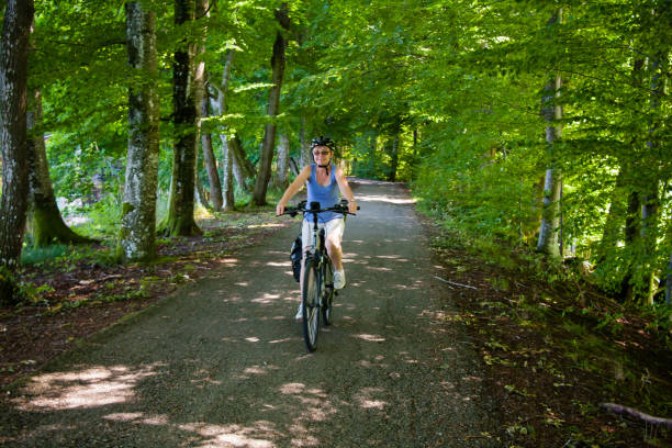 istock Cyclists on gravel path with trees 1309140563