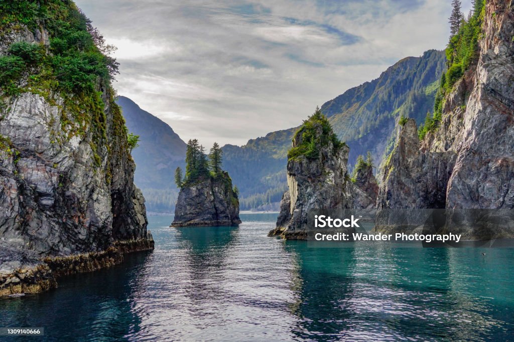 Spire Cove Rock Formations and Turquoise Waters of Spire Cove in the Kenai Fjords National Park. Seward, Alaska Alaska - US State Stock Photo
