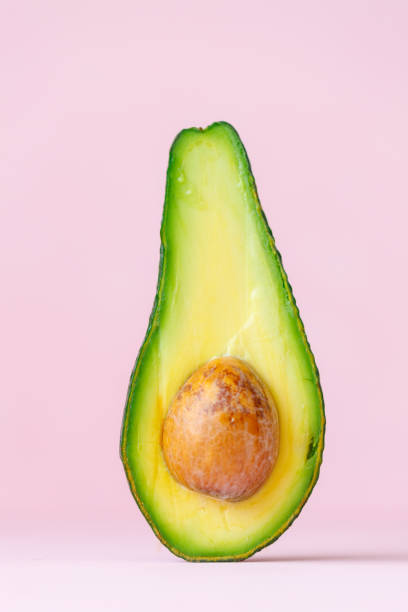 istock half ripe avocado on pink background or wooden chopping board 1309141992