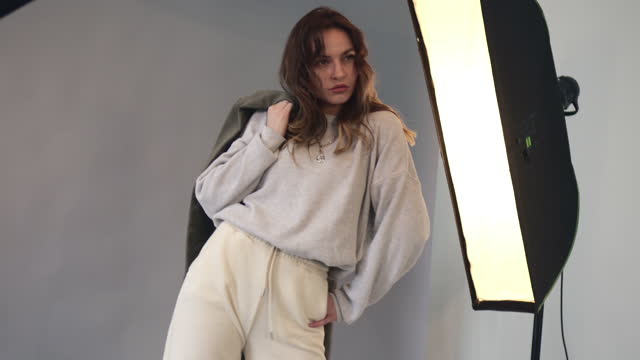 Female model posing at studio during photo shoot.