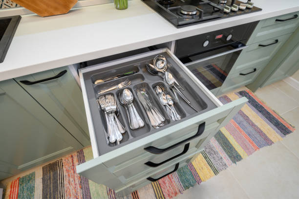 istock Drawer pulled out in cabinet at luxury teal and white modern kitchen furniture 1309144381