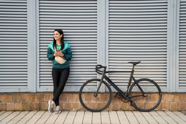 istock Smiling beautiful lady in sportswear using wireless headphones 1309145218