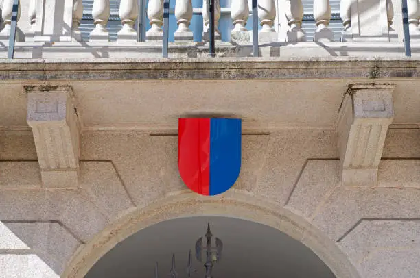 Coat of arms of Canton Ticino hanging at the entrance gate of official Government building also know as Palazzo delle Orseline in the city center in Bellinzona, Switzerland