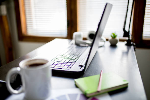 Home office working place with laptop, cup of coffee, notebook and diagram