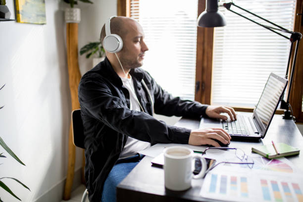 istock Man working from home, sitting in front of laptop computer having meeting over internet 1309147482