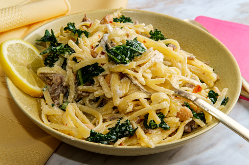 Linguine pasta with Italian sausage chickpeas and kale in a creamy ricotta cheese sauce