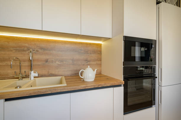 istock Modern white and beige wooden kitchen interior details 1309148402