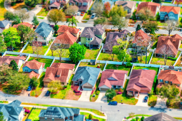 Housing Development Abstract Full frame, aerial view of a group of houses in a residential development using a tilt-shift technique to make the homes appear as a possible miniature model. tilt shift stock pictures, royalty-free photos & images