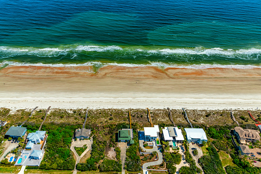 Aerial view of luxury beachfront homes in suburban north Florida along the Atlantic Coast.