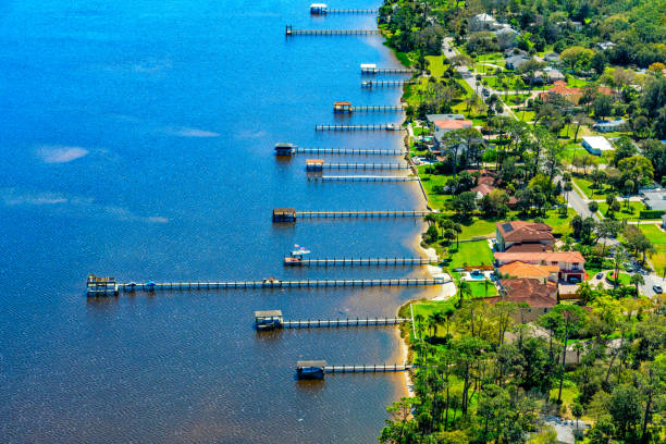 Boat Dock Aerial Aerial view of a group of residential boat docks from homes along the Halifax River in Ormond Beach, Florida near Daytona. daytona beach stock pictures, royalty-free photos & images