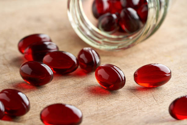Krill oil pills spilled from a glass jar