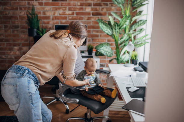 istock Modern mom and baby son in office 1309151059