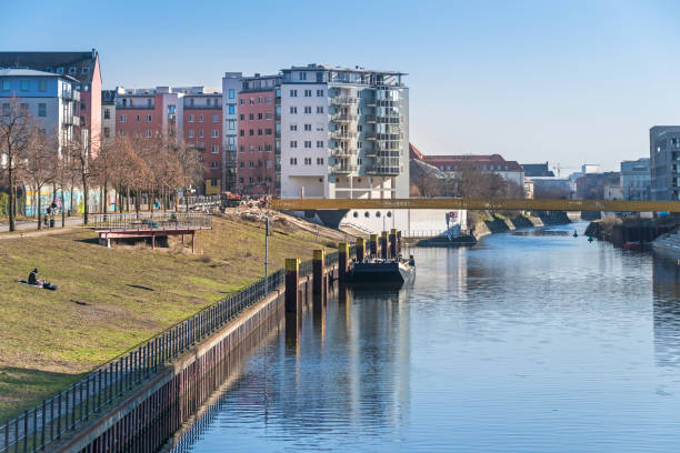 New bridge under construction over the Berlin-Spandau shipping canal in Berlin, Germany Berlin, Germany - March 1, 2021: Sunbathing lawn at Nordhafen harbor with the new bridge Golda-Meir-Steg under construction over the Berlin-Spandau shipping canal moabit stock pictures, royalty-free photos & images