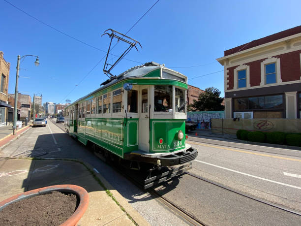 Memphis, Tennessee - March 21, 2021: Green electric trolley traveling down Main Street in downtown Memphis, Tennessee.