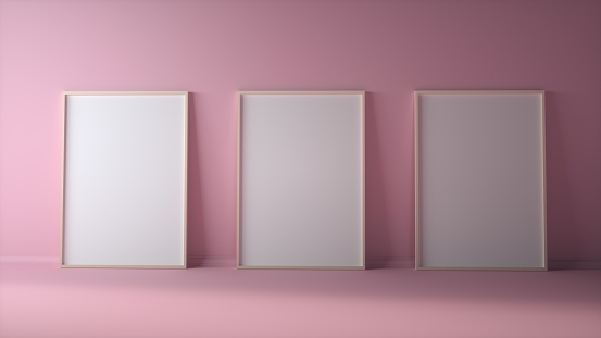 Blank three photo frames on light pink wall mock up. 3d rendering.