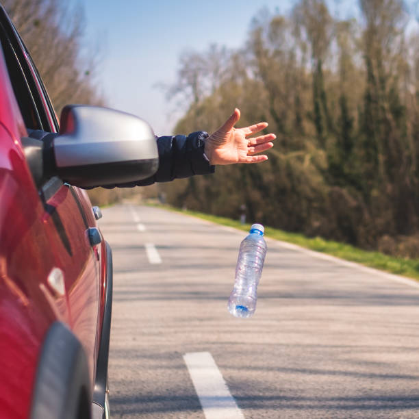 istock red car driver throwing away plastic waste from the car 1309160988