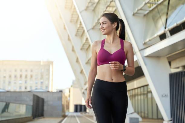 istock Smiling beautiful sportswoman going along the stadium 1309165019