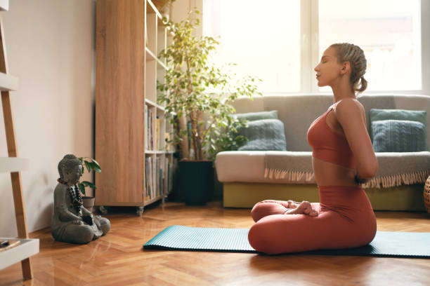 istock Side view of a young woman practicing yoga while doing reverse prayer pose 1309165174
