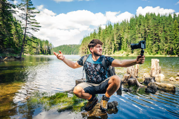 istock Young explorer photographing nature and vlogging. 1309166459