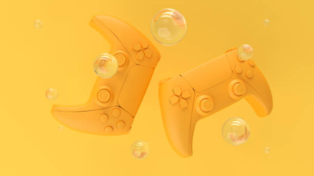 Yellow standard videogame controllers on a yellow background with pattern dots and holes. Transparent soap bubbles with reflections. Gamepads for game console