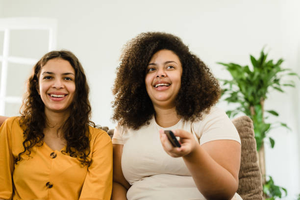 istock Smiling friends watching tv 1309187624