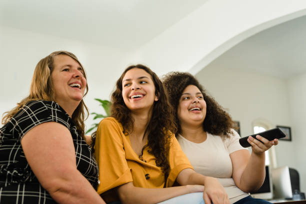 istock mother and daughters watching television 1309187691