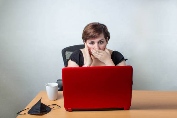 istock woman watching computer with surprised face at job offer 1309188626