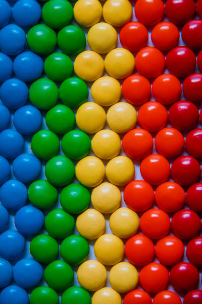 istock Brightly colored sweet candies laying flat. Rainbow candy background 1309198120