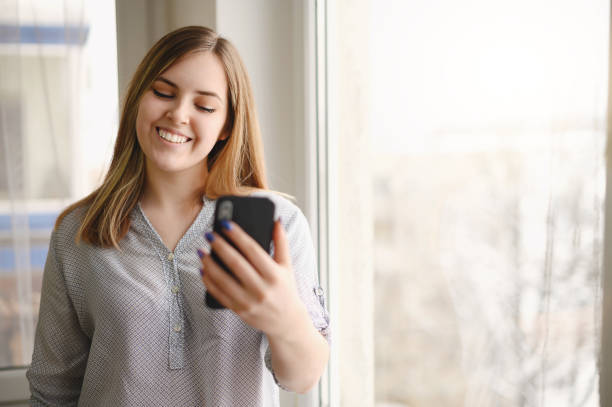 istock Young pretty woman talking via cell phone, video call 1309200592