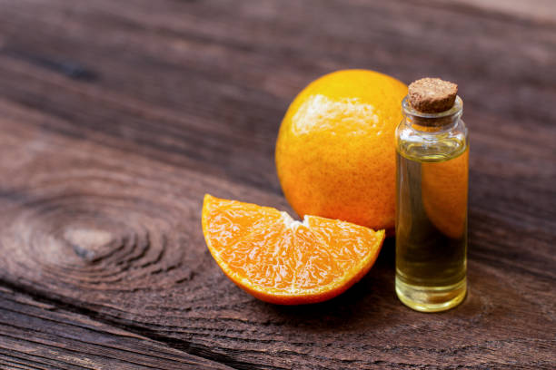 istock Orange essential citrus oil with orange fruit isolated on wood table 1309200839